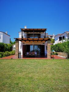 a house with a patio and a grass yard at Luxury Sea View Vila 125m2 in Siviri