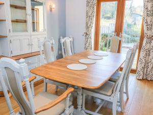 a dining room with a wooden table and chairs at Langtree in Carnforth