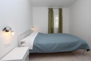 Łóżko lub łóżka w pokoju w obiekcie Apartments Palaziol