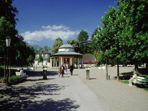 a group of people walking around a pavilion in a park at Gästehaus Spieker in Horn-Bad Meinberg