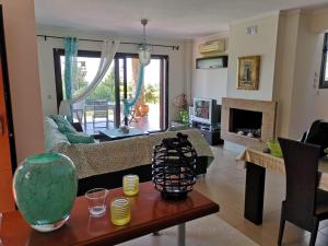 a living room with a couch and a table at Luxury Sea View Vila 125m2 in Siviri