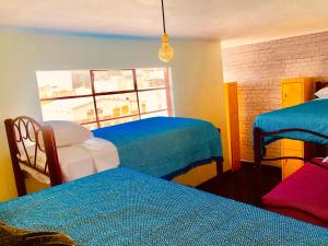 Ένα ή περισσότερα κρεβάτια σε δωμάτιο στο Casa Eufemia Hostel type