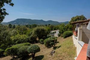 a view of a garden with bushes and trees at U Paesolu in Sainte-Lucie de Porto-Vecchio
