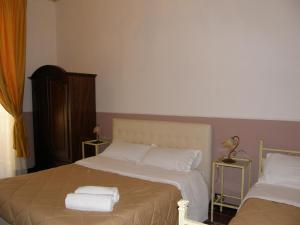 A bed or beds in a room at Il Gattopardo House