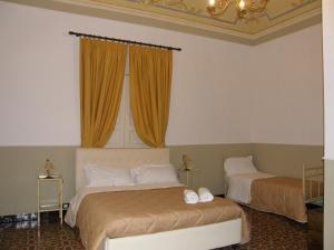 A bed or beds in a room at Il Gattopardo House