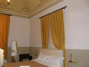 A bed or beds in a room at Il Gattopardo House