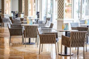 a row of tables and chairs in a restaurant at Grupotel Los Príncipes & Spa in Playa de Muro