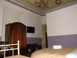 A bed or beds in a room at Il Gattopardo House