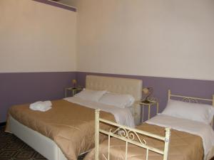 A bed or beds in a room at Il Gattopardo House
