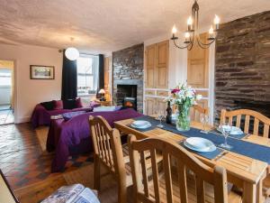 a kitchen and living room with a table and a couch at 12 Victoria Terrace in Nantlle