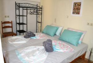 a bedroom with two beds with towels on them at Marilia Home in Kounoupidhianá