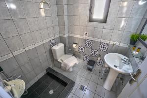 a small bathroom with a sink and a toilet at Saffroni Inn in Paralia Katerinis +73 photos