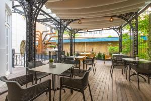 a restaurant with tables and chairs on a deck at Public House Hotel in Belgrade