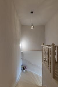 a hallway with a staircase with a pendant light at Geant Suites Mykonos in Mikonos +43 photos