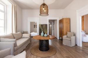 a living room with a couch and a table at Geant Suites Mykonos in Mikonos