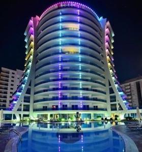 a large building with a pool in front of it at Calista Premium Residence in Alanya