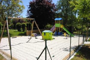 a playground with a play equipment in a park at LES PIERRES CHAUDES in Veyrignac