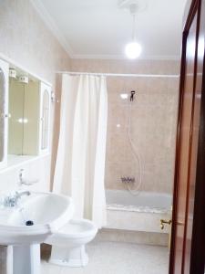 a bathroom with a sink and a shower and a toilet at Casa de Campo in Malpica +48 photos