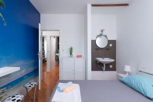 a bedroom with a white bed and a sink at Rooms Hvar in Hvar +48 photos
