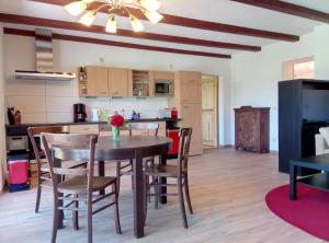 a kitchen and dining room with a table and chairs at Ferienwohnung Porschendorf in Porschendorf +29 photos