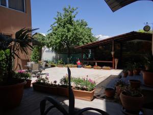 a patio with lots of potted plants and flowers at Areg Hotel in Yerevan