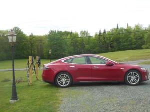 a red car is parked next to a street light at Sugar Hill Inn in Sugar Hill