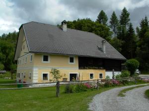 a large yellow house with a black roof at 2 - 6 Person Holiday Apartment in Pichl