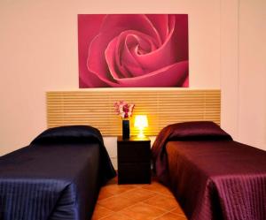 Postel nebo postele na pokoji v ubytování Villa Smeraldo Roma