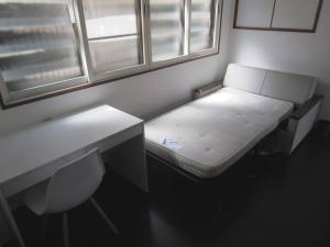 a room with a bench and a desk and windows at Yuzawa Condo 一棟貸 貴重な駐車場2台無料 in Yuzawa
