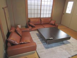 a living room with a couch and a coffee table at Yuzawa Condo 一棟貸 貴重な駐車場2台無料 in Yuzawa
