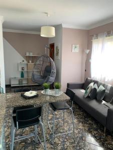 a living room with a couch and a table at Vacacional Tegueste 2ºB in Vecindario