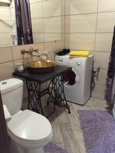 a bathroom with a sink and a washing machine at Heart of Lviv in Lviv