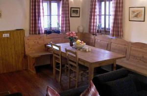 a dining room with a wooden table and chairs at 2 - 6 Person Holiday Apartment in Pichl