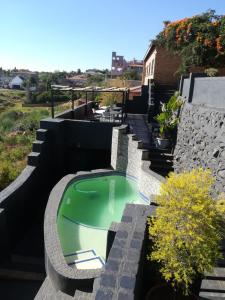 a swimming pool on the side of a house at Arek's Place in Krugersdorp