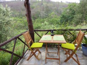 a table and chairs on a balcony with a view at Casa da Eira in Cerdeira