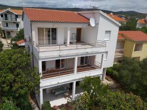 an aerial view of a white building with a balcony at Villa Tina in Rogoznica