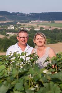 a man and a woman standing in front of a bush at La Boulonne in Festigny