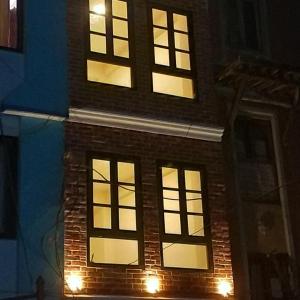 a brick building with lit windows at night at Sayami Home in Pātan