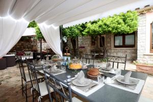 a dining table with chairs and a white tent at Relais 147 - Luxury b&b in Taormina