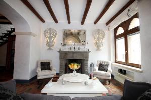 a living room with a fireplace and a table at Relais 147 - Luxury b&b in Taormina