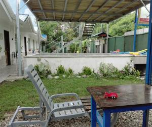 a table and chairs with a toy truck on a table at Tropical Housing by El Rodeo - Calle El Manglar in Puerto Jiménez