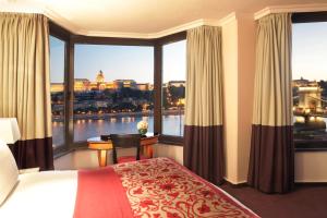 a hotel room with a bed and a large window at Sofitel Budapest Chain Bridge in Budapest