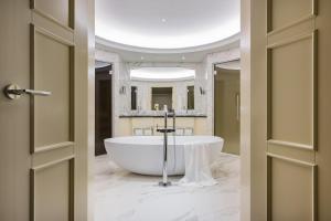 
a bathroom with a sink and a bath tub at Grand Hotel Kempinski Riga in Riga
