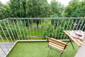 a balcony with a bench and a view of a yard at Bliss Apartments in Poznań