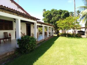 a porch of a house with a grass yard at Casa Porto de Pedras_Patacho_Milagres in Pôrto de Pedras +45 photos