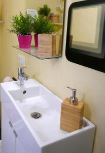 a bathroom with a white sink and a mirror at Casa Valle de Palmeras in Haría