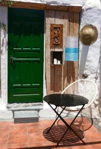 
a wooden bench sitting in front of a door at Casa Valle de Palmeras in Haría
