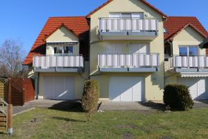 a house with balconies on the side of it at Ferienwohnung Strandaster in Zingst