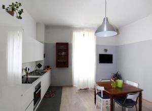 a kitchen with a table and a dining room at Plose Apartment in Bressanone