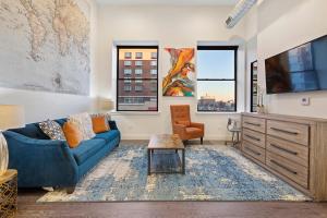 a living room with a blue couch and a tv at Luxury City Escape in Newark